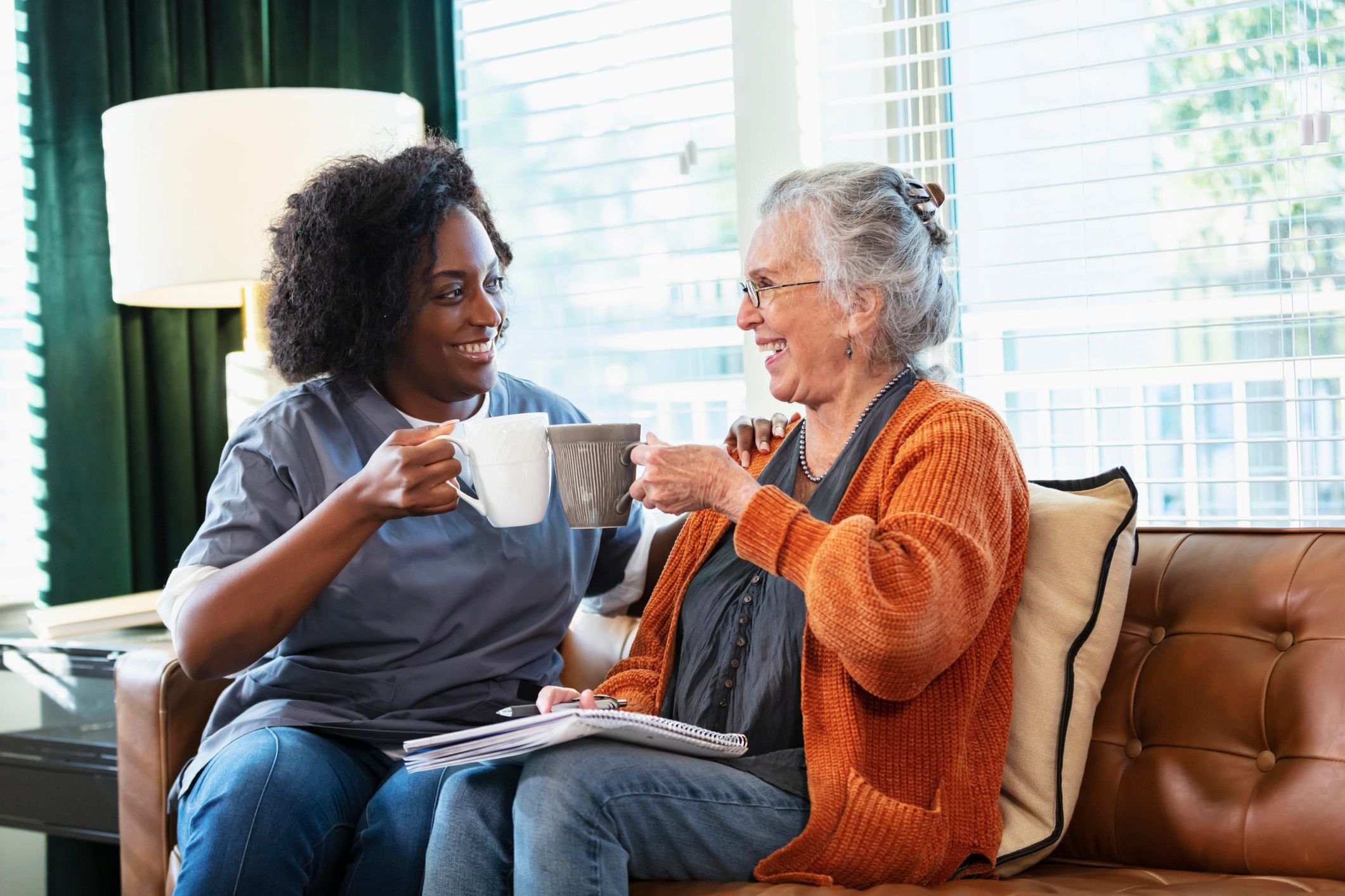 Home caregiver talking with a senior client